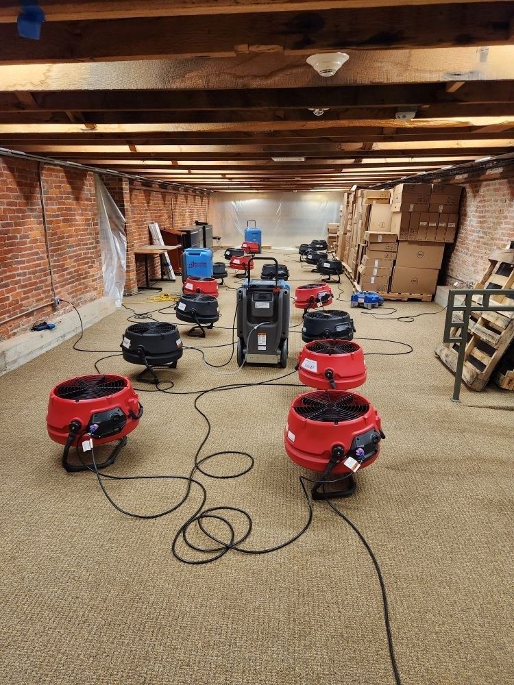 A warehouse filled with lots of industrial vacuums, heaters and fans.