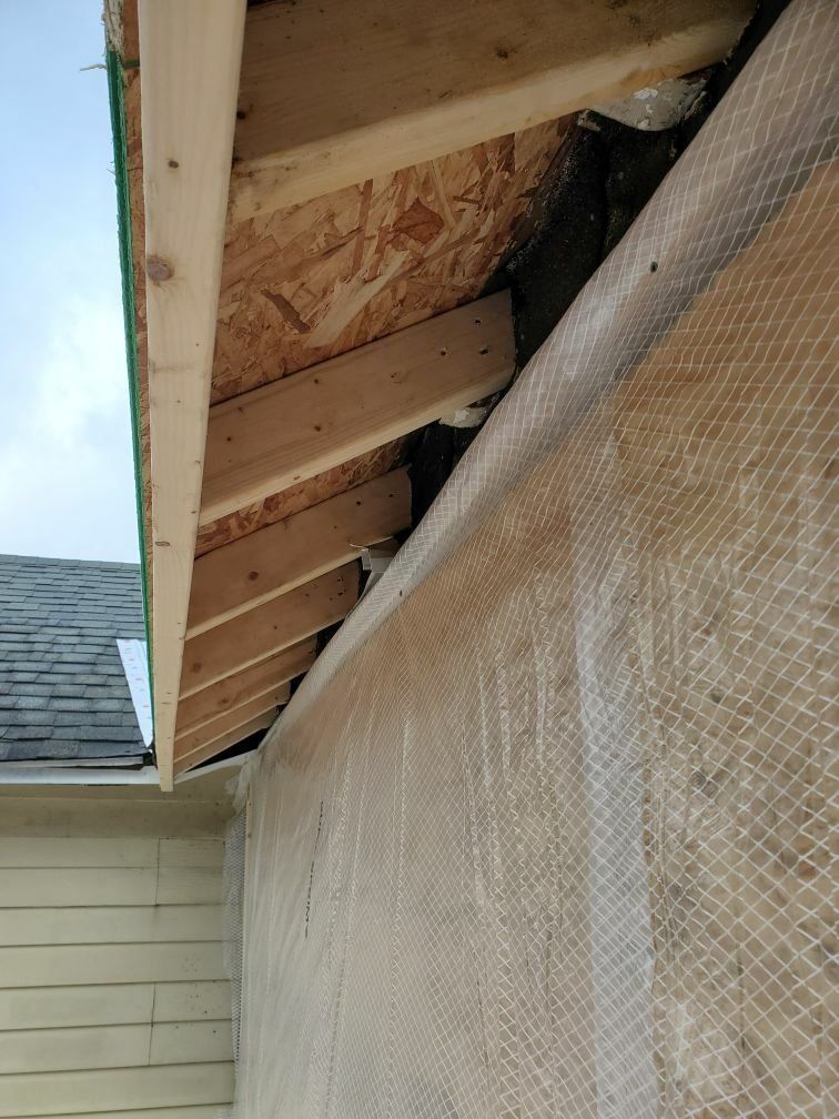 A house with a roof that is being built and a gutter.