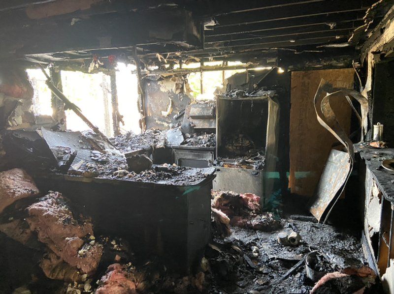 Room full of rubble which has been destroyed in a fire.