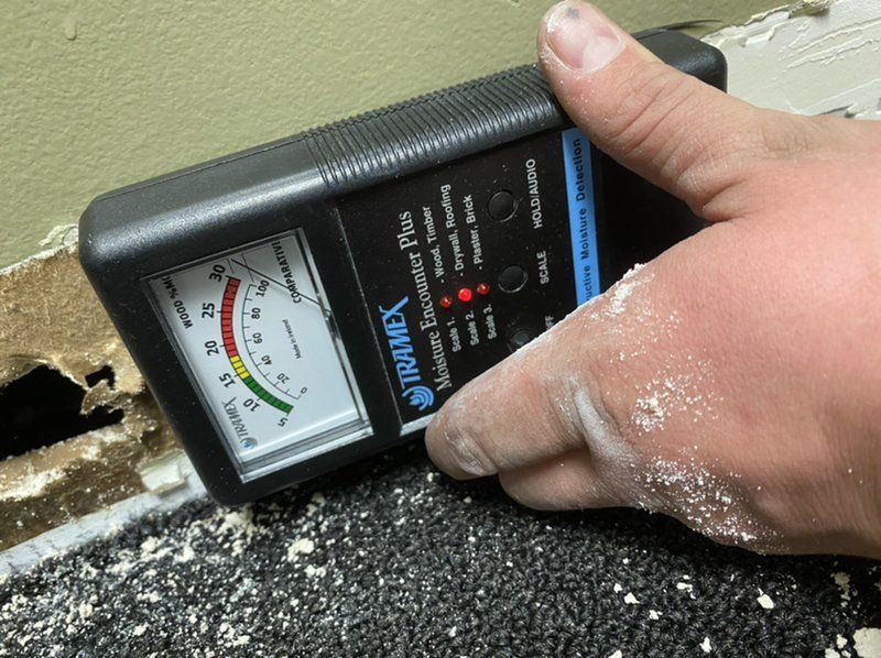 Moisture Meter running tests to see how moist the area is.