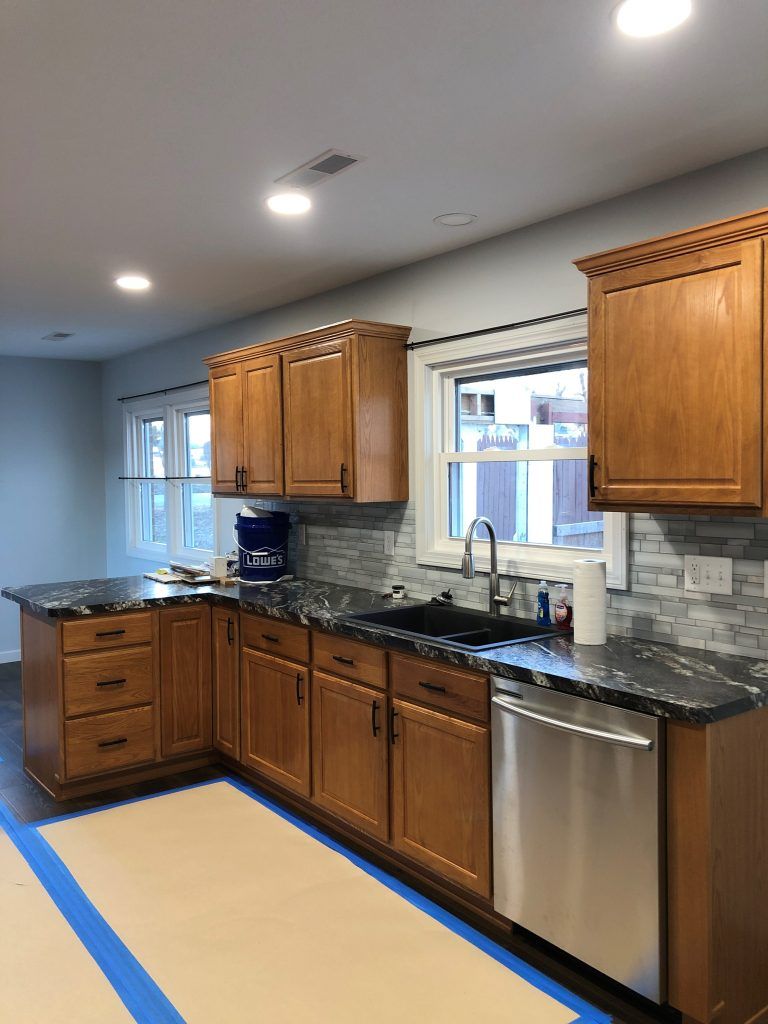 A kitchen with wooden cabinets and stainless steel appliances.