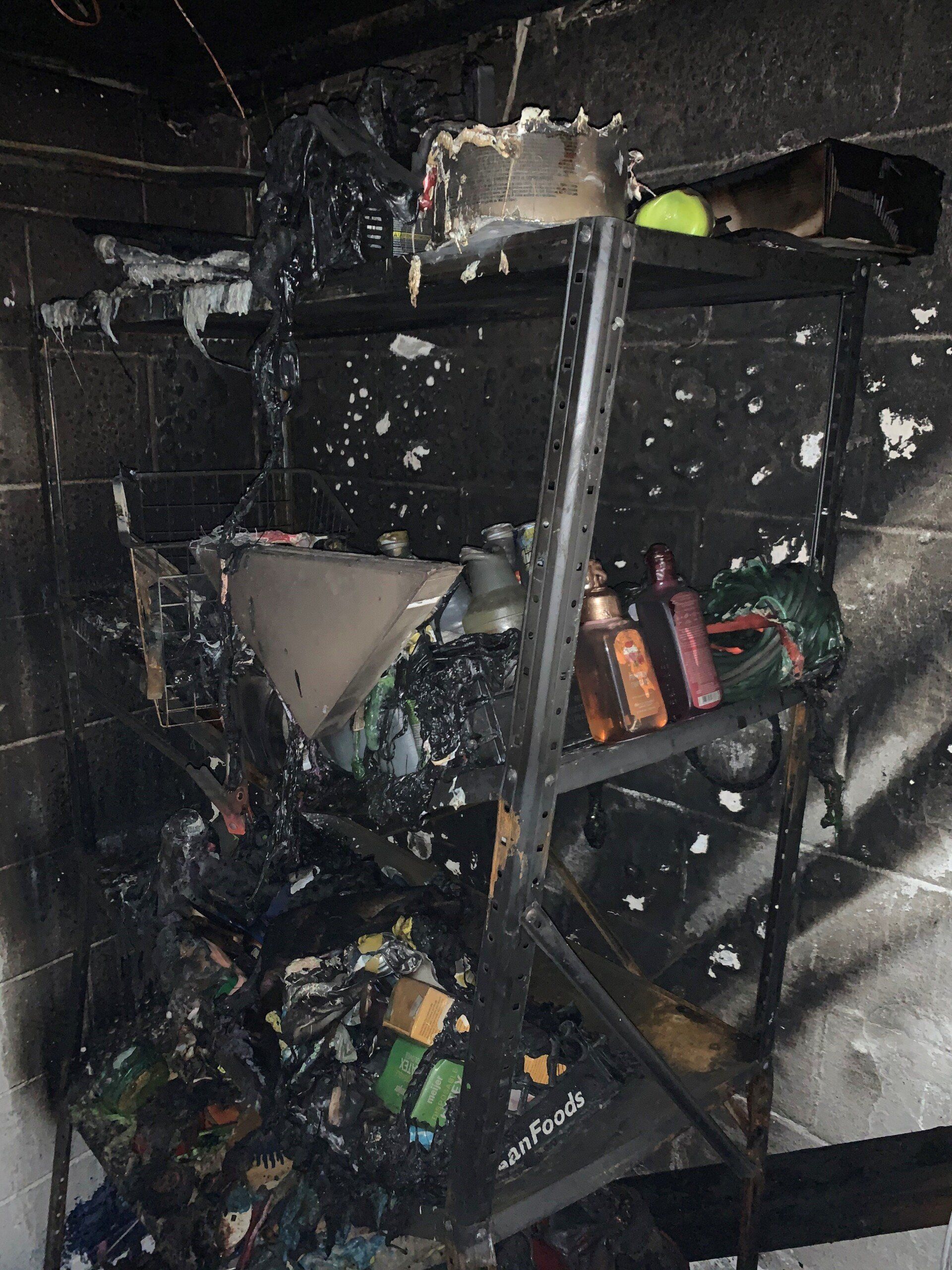 A shelf in a room that has been damaged by a fire.