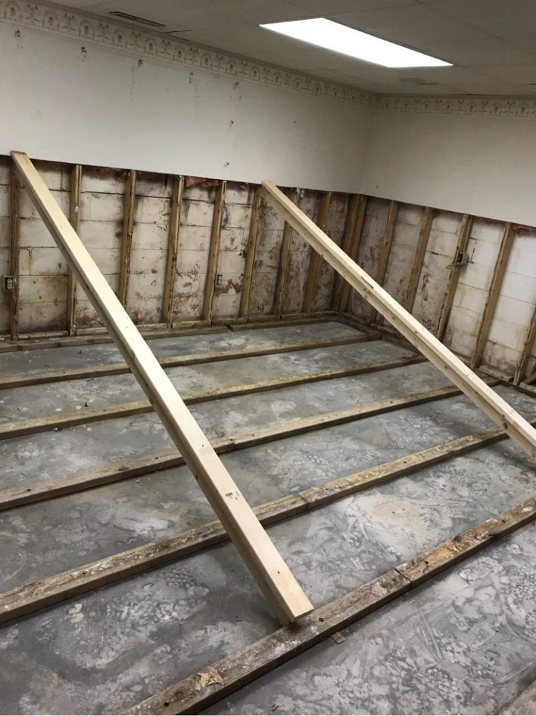 A room with a lot of wooden beams on the floor.