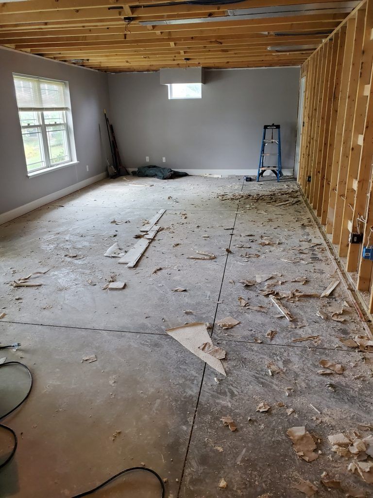 A room with a ladder and wood floor. 