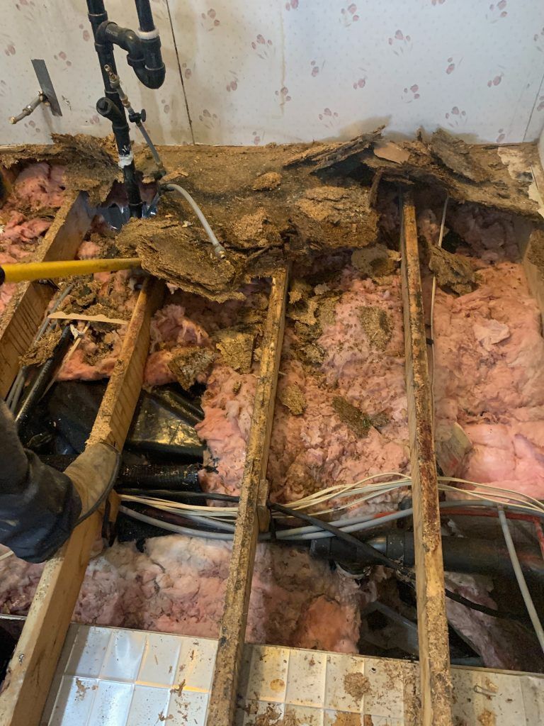 A person is working on the floor of a house.