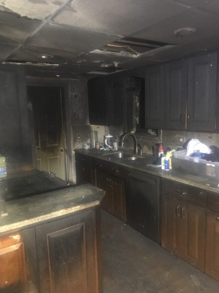 A kitchen that has been damaged by a house fire. 