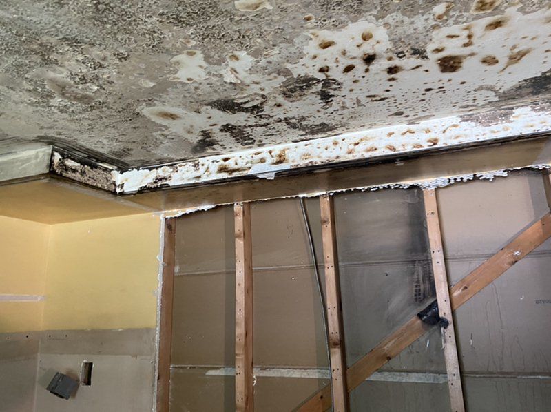 A room with a ceiling that is fire damaged.