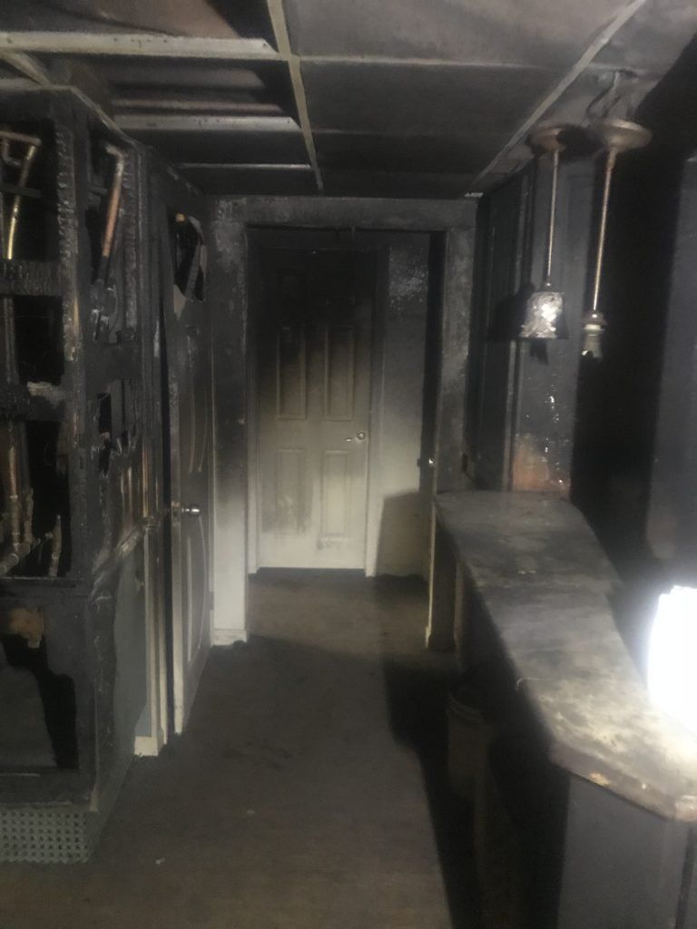 A room with black smoke damage from house fire.  