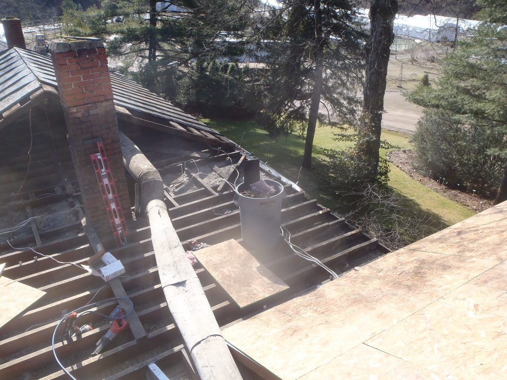 A chimney and roof which has been damaged by a house fire.