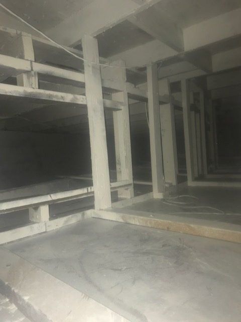 A very dark room with a lot of columns and pillars.