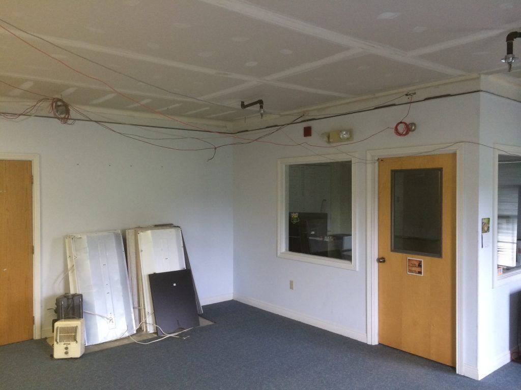 An empty room with two doors and a window.