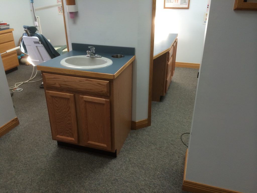 A bathroom with a sink and cabinets in it.