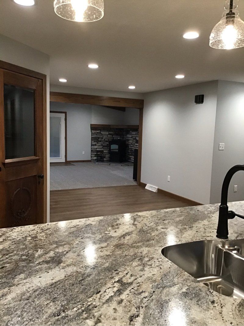 A kitchen with a granite counter top and a sink.
