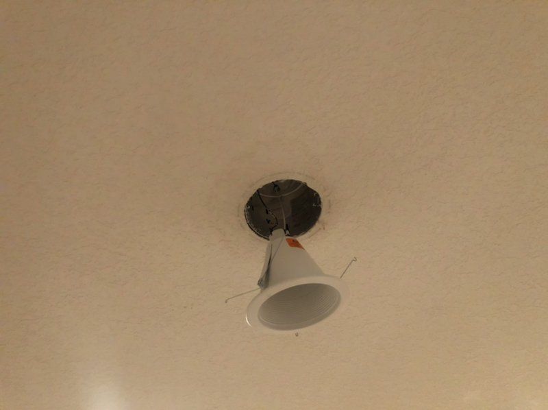 A white light fixture is hanging from the ceiling.