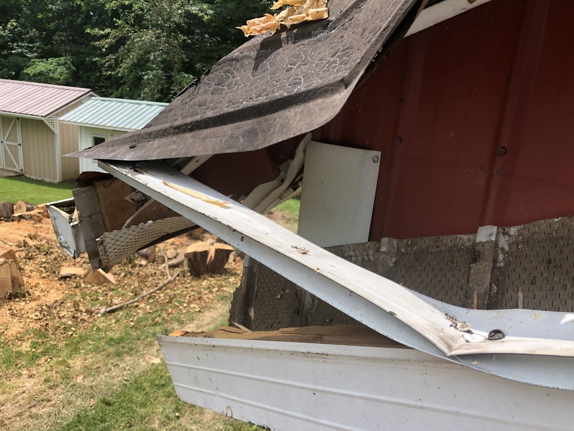 The gutters of the garage all bent up from the fall of the tree.
