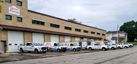 Rainbow International Restoration vehicles linked in front of the Rainbow Restoration building.