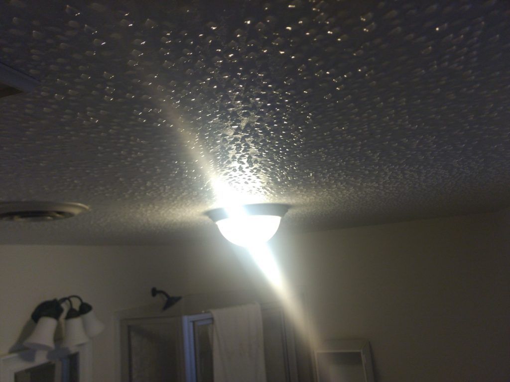 A room with a light on the ceiling.