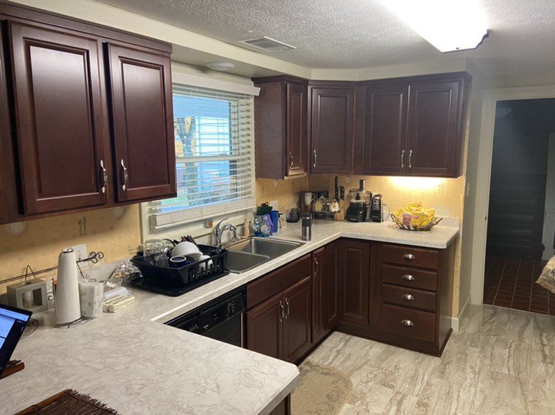 A kitchen with wooden cabinets and a sink.