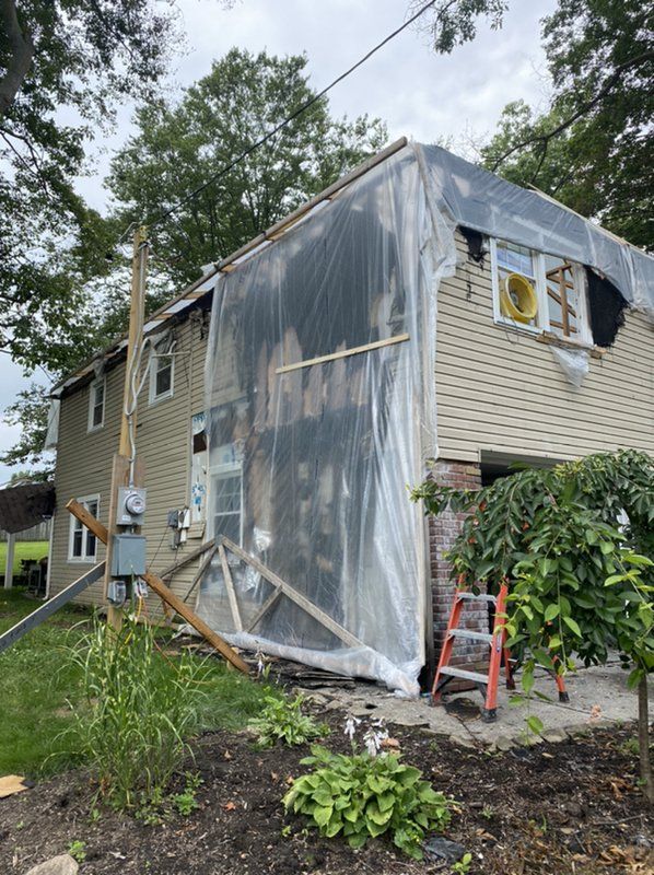 A house is being remodeled and covered in plastic.