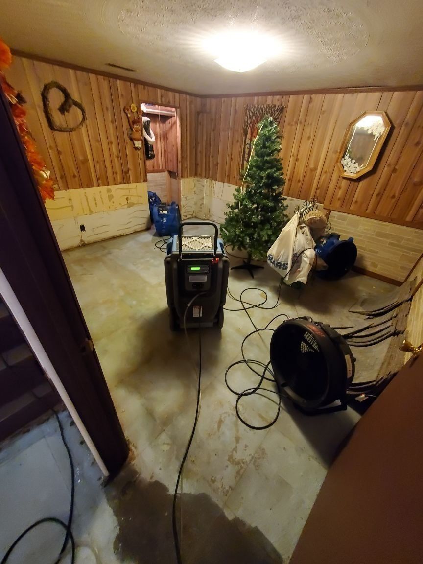 A room with a Christmas tree and industrial machines within. 
