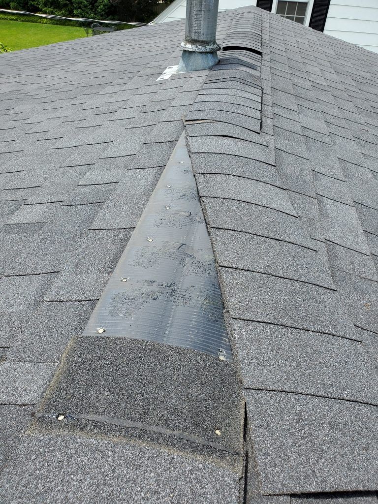 A close up of a roof with a chimney on top of it.
