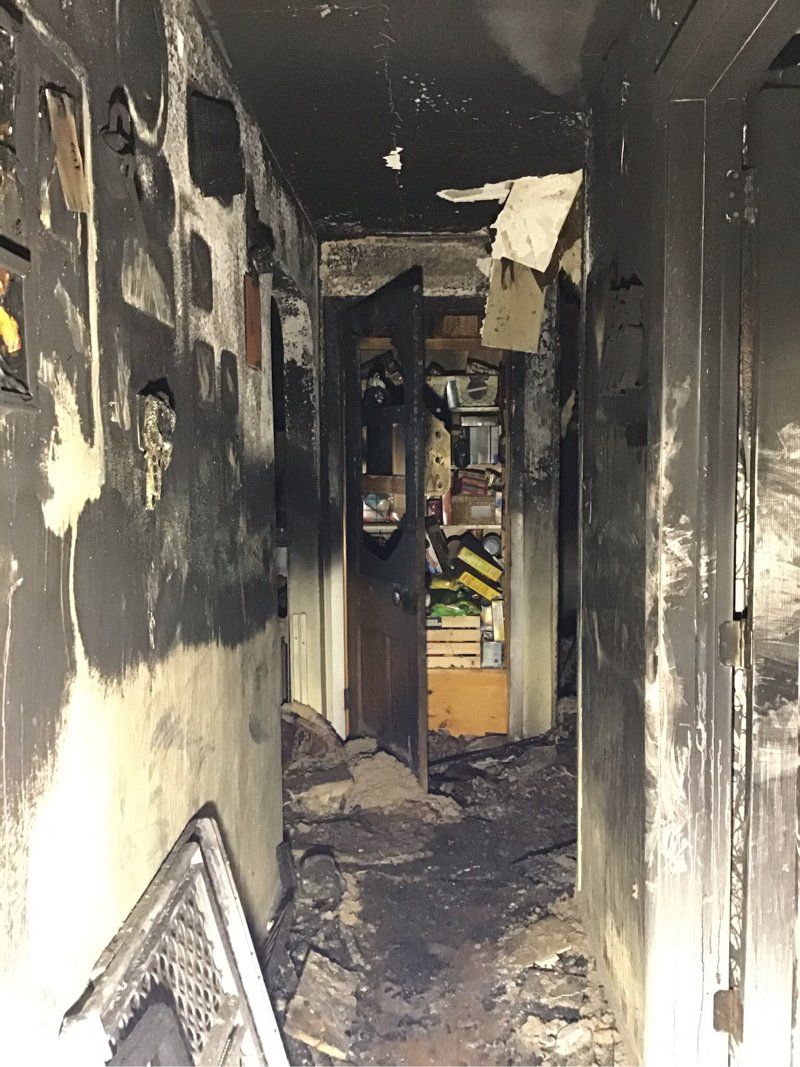 The hallway of a house that has been damaged by fire.
