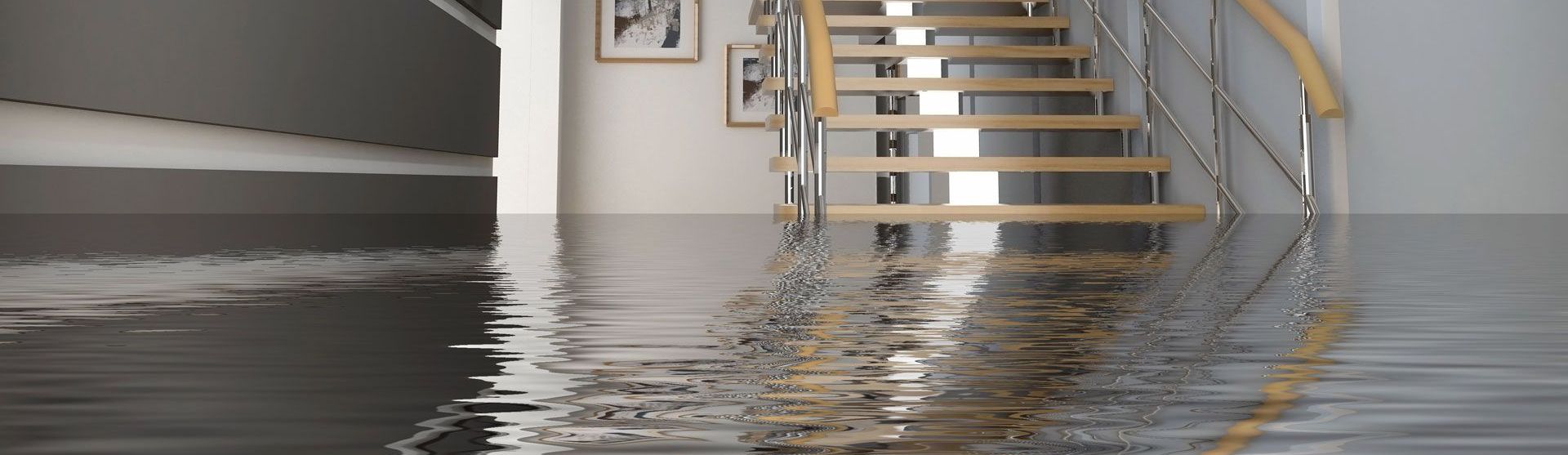 A flooded hallway with stairs and a reflection of stairs in the water.
