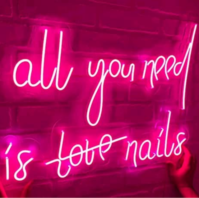 A neon sign that says all you need is love nails