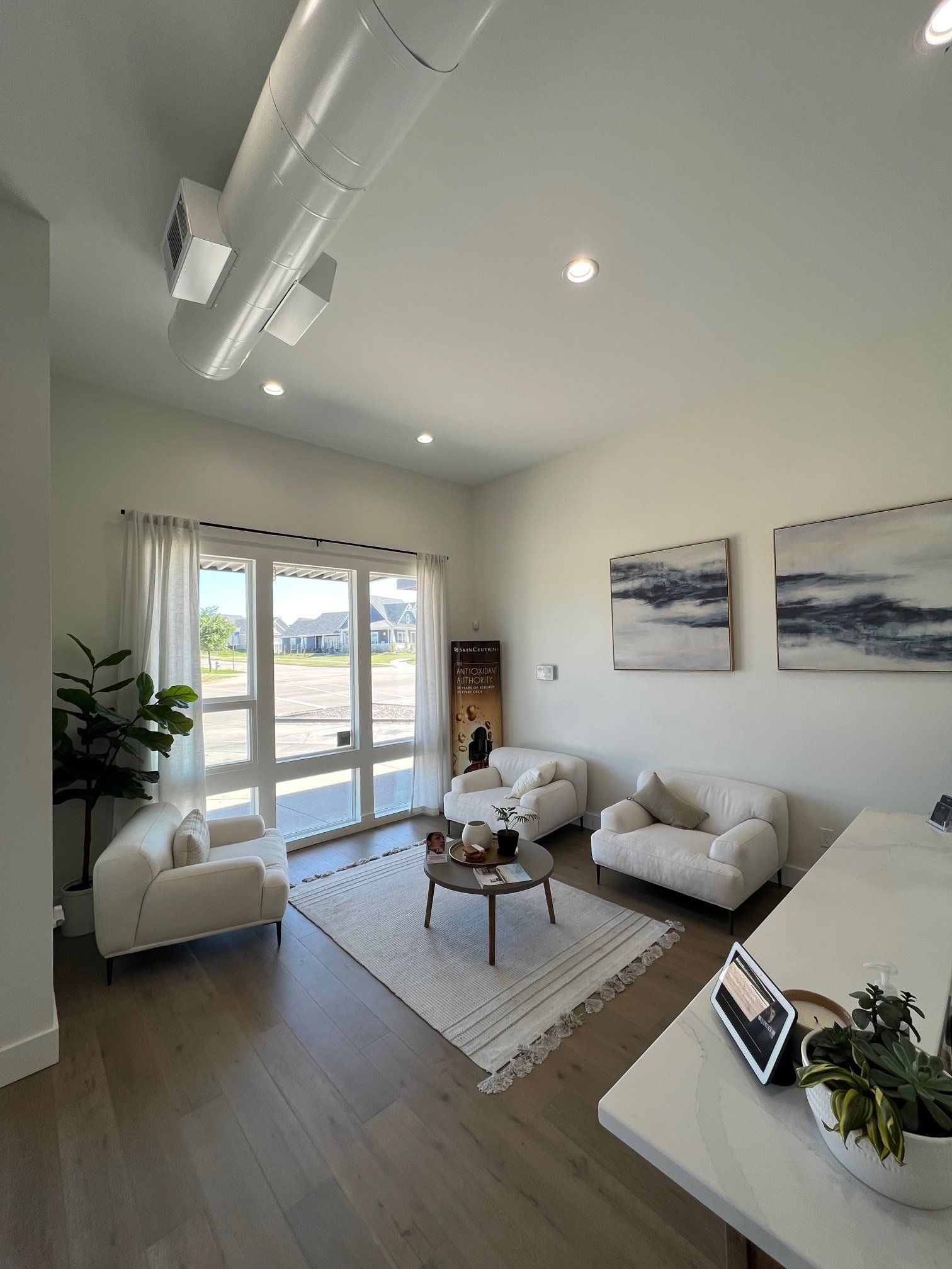 A living room with a couch , chairs , and a coffee table.