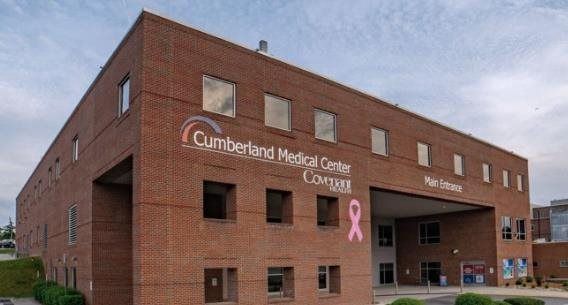 Brick medical office building with Ontario Medical Oncology sign and pink ribbon symbol