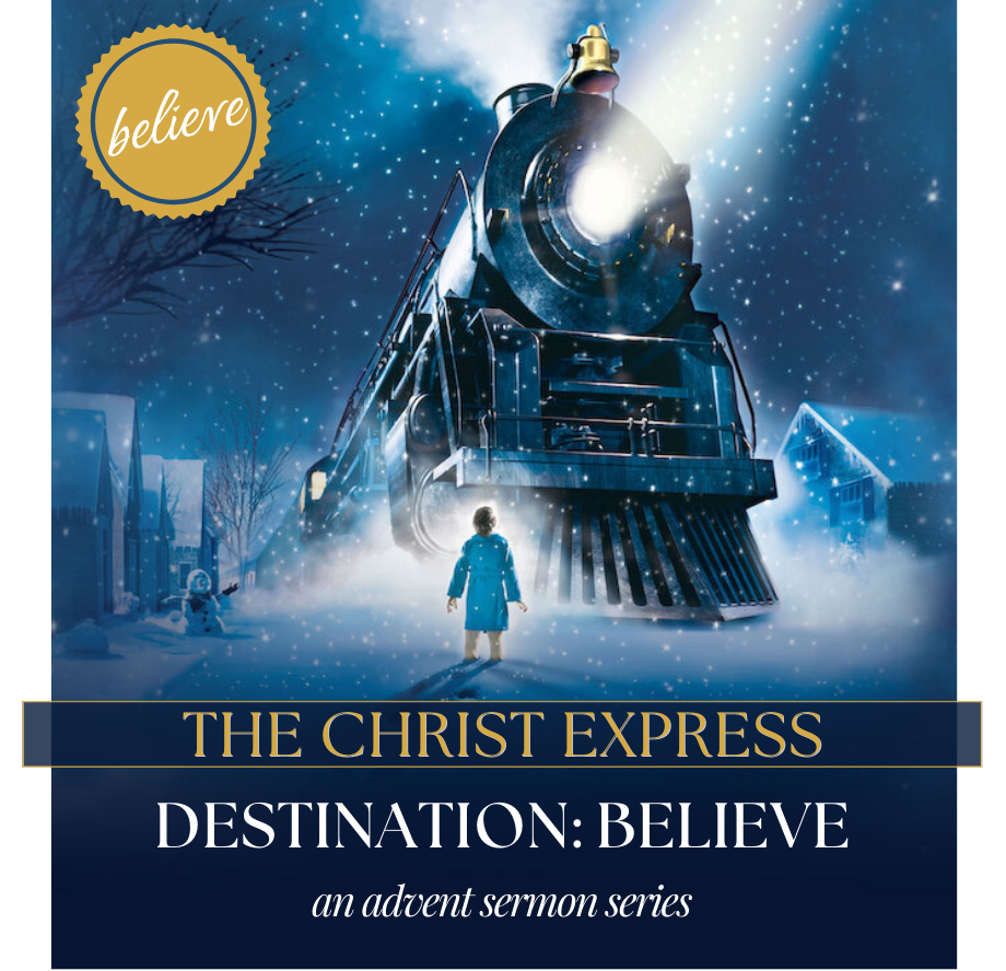 A boy in blue stands before a train. 