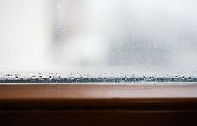 A close up of a window with condensation on it.