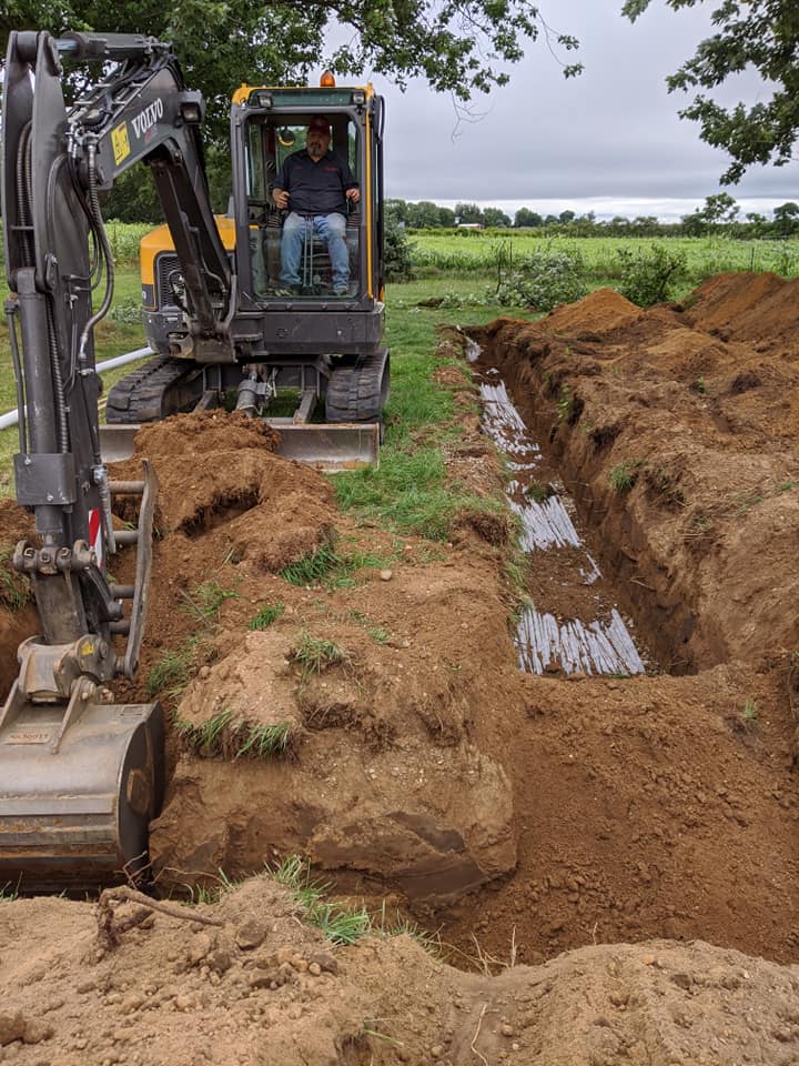 Excavator preparing site — White Pigeon, MI — Mercers Septic & Excavating LLC Excavator preparing site — White Pigeon, MI — Mercers Septic & Excavating LLC