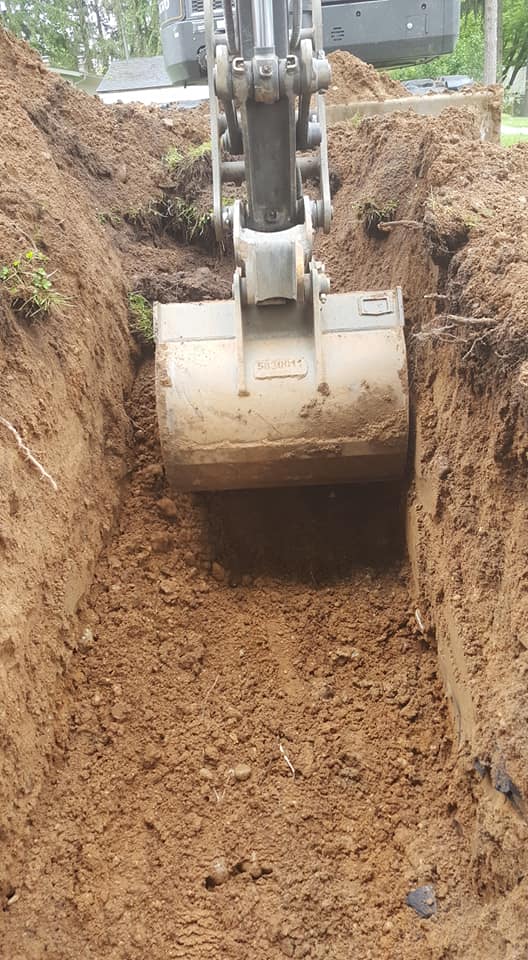 Excavator digging up hole for septic tank — White Pigeon, MI — Mercers Septic & Excavating LLC Excavator digging up hole for septic tank — White Pigeon, MI — Mercers Septic & Excavating LLC