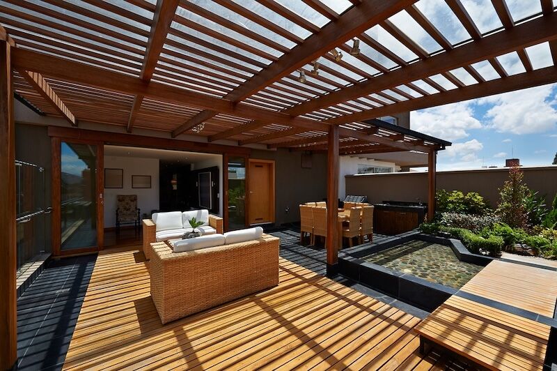 A patio with a wooden pergola and wicker furniture — Nicho's Home Maintenance In Tamworth, NSW
