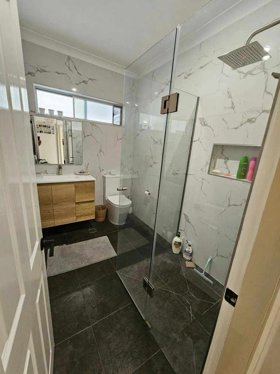A Bathroom with A Walk in Shower, Toilet, Sink and Mirror — Nicho's Home Maintenance In Tamworth, NSW