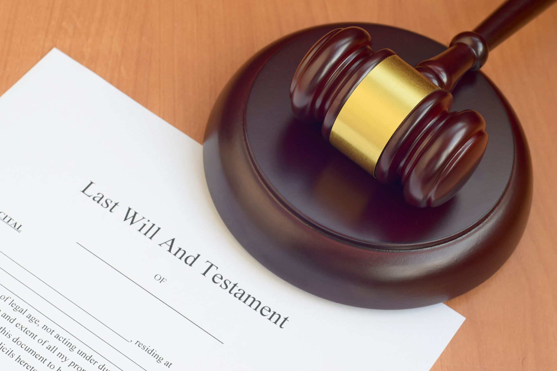 A gavel rests on a wooden block beside a 