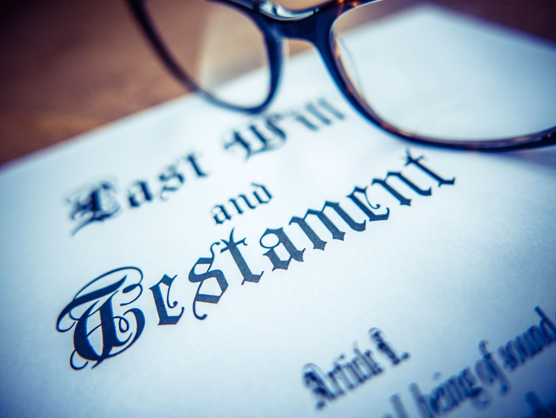 Last Will and Testament document with eyeglasses resting on top.