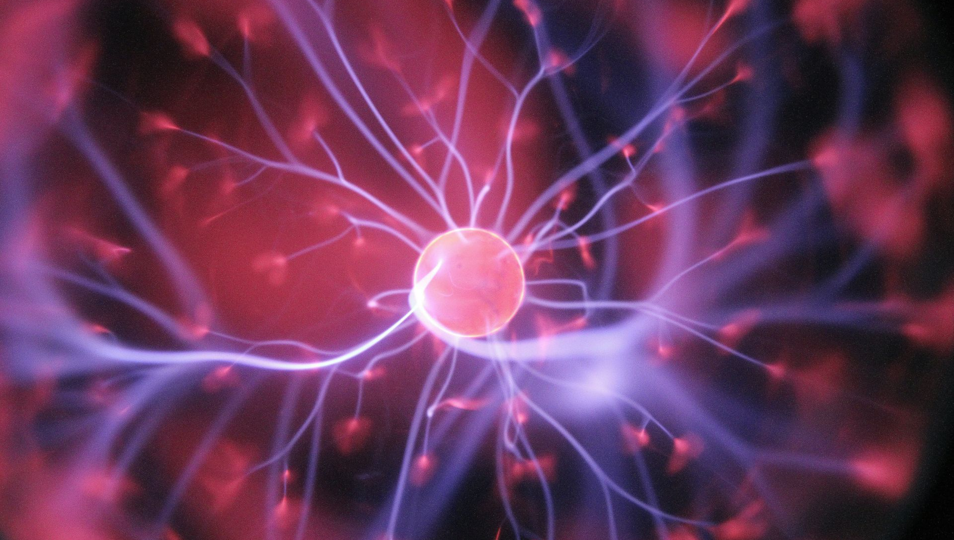 Plasma ball, central glowing orb with branching purple and red electrical discharges.