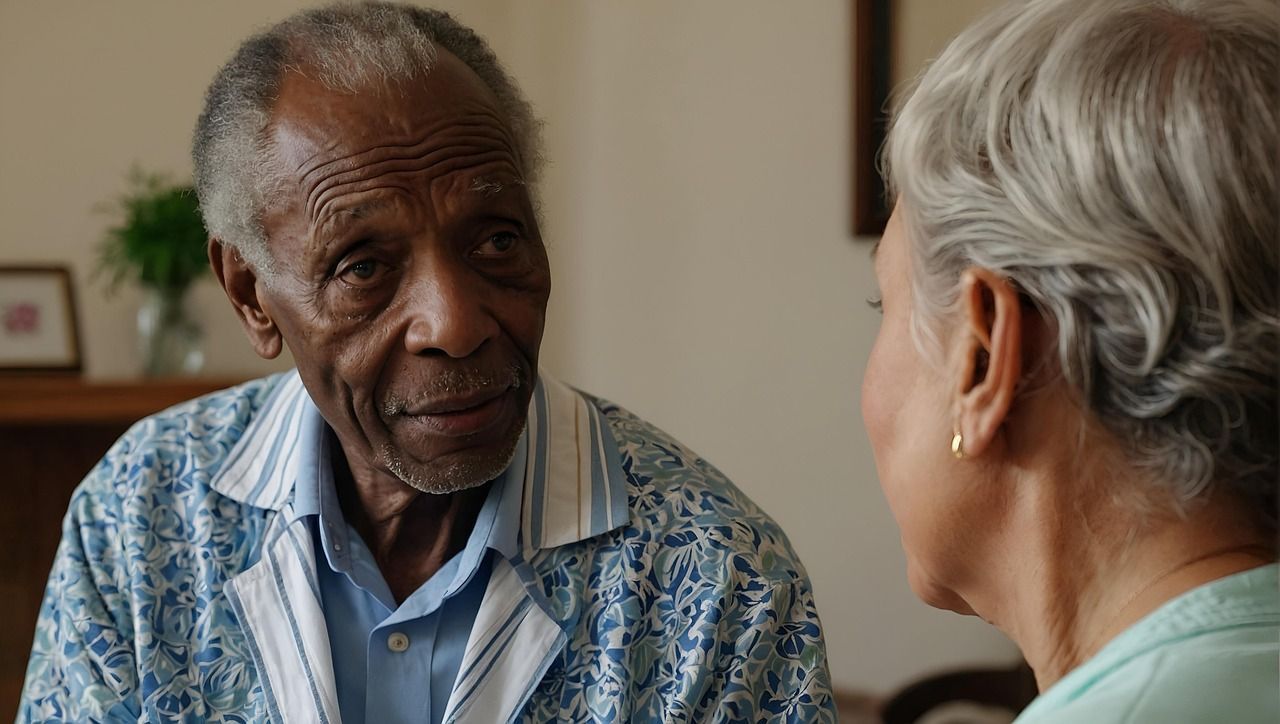 An elderly man and woman are talking to each other in a living room.
