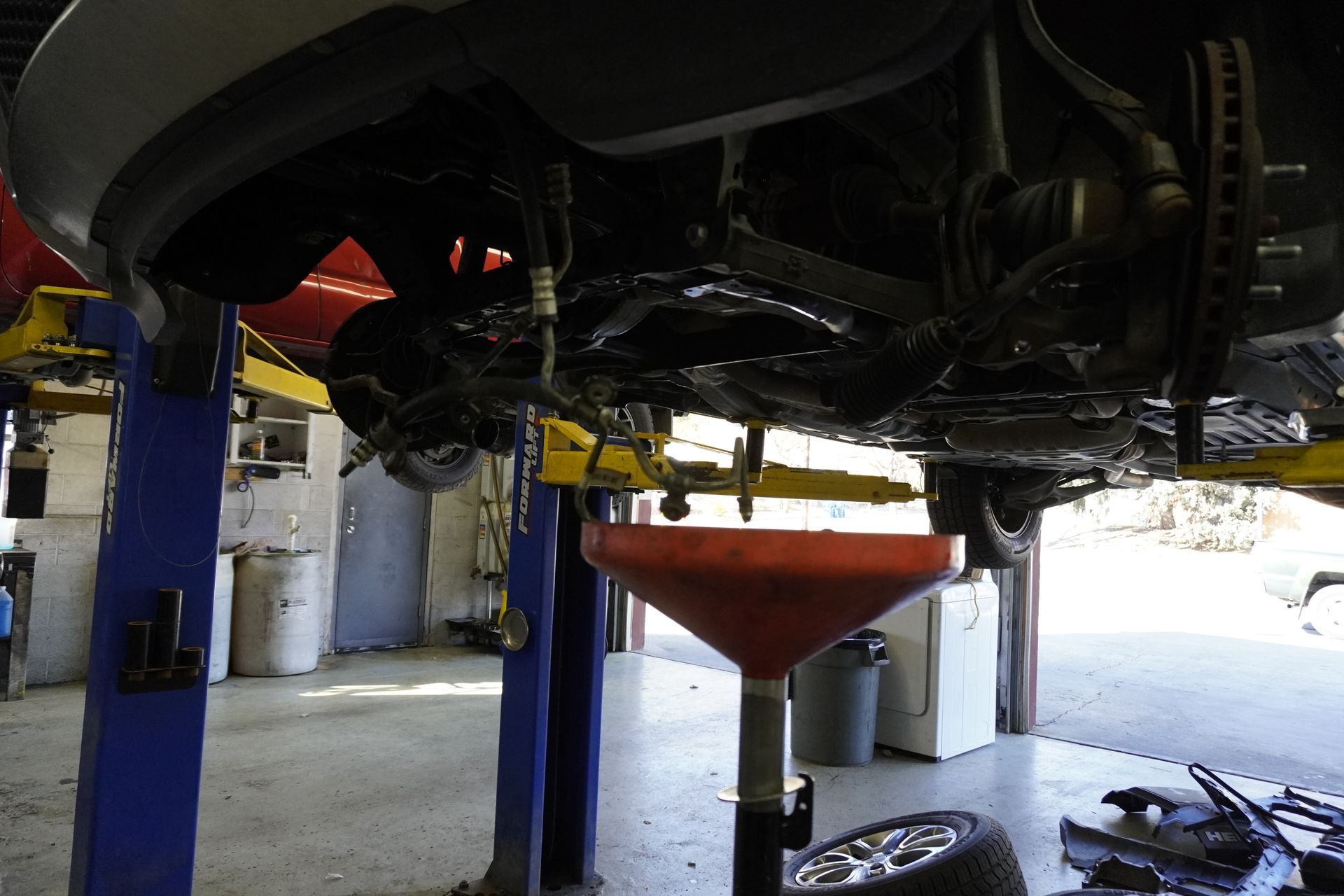 West Highlands Auto Repair changing oil, draining oil