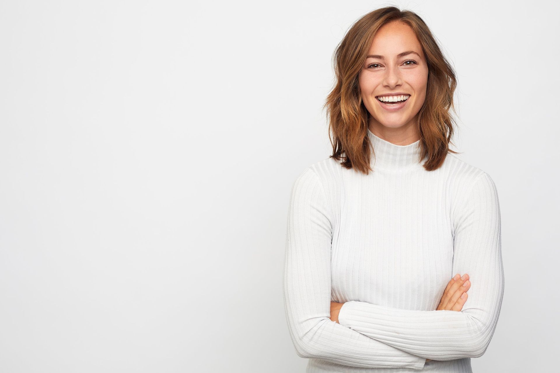 Woman With Wavy Brown Hair, Wearing a White Turtleneck — New Leaf Dentists In Erina, NSW