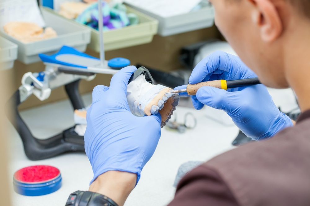 Dental Technician Meticulously Carves Dental Mold
