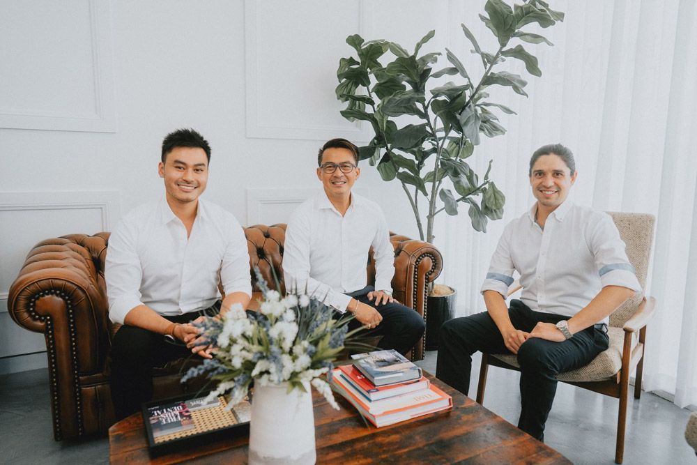 Three Men in White Shirts Seated — New Leaf Dentists In Erina, NSW
