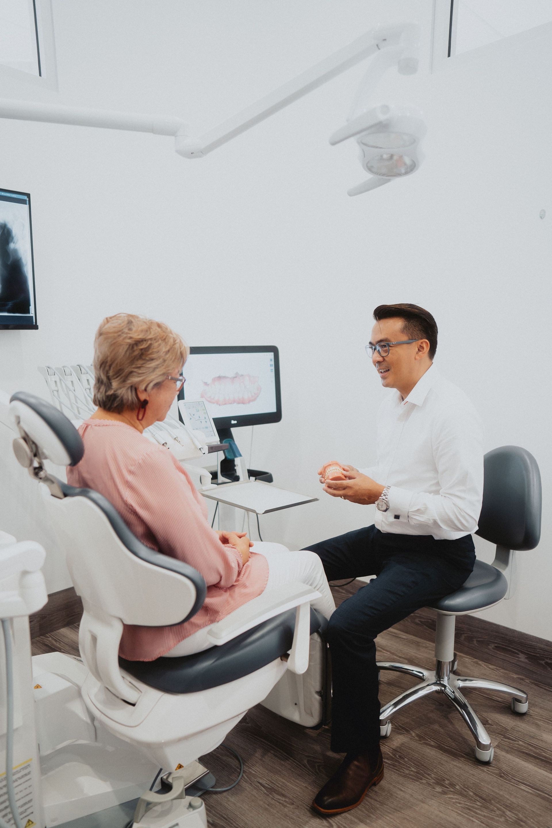 Dentist Showing Model Teeth to a Patient — New Leaf Dentists In Erina, NSW