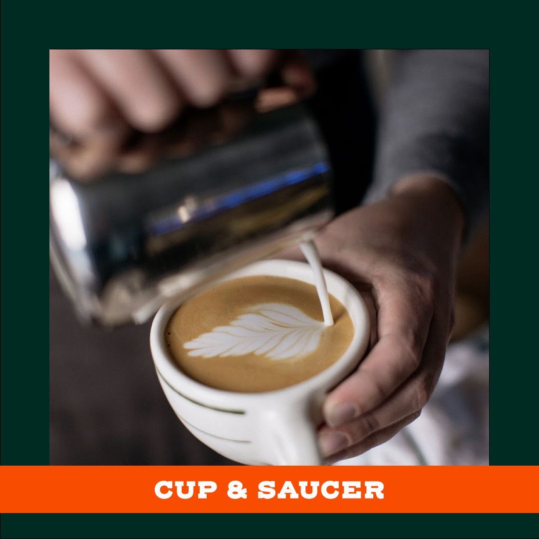 A person is pouring milk into a cup of coffee with the words cup & saucer below it