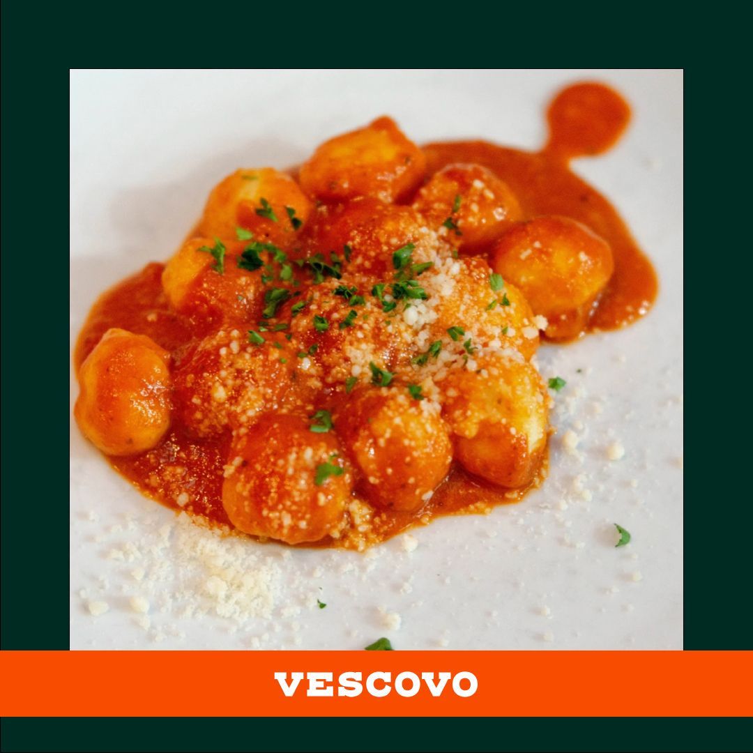 A plate of vescovo gnocchi with sauce and cheese