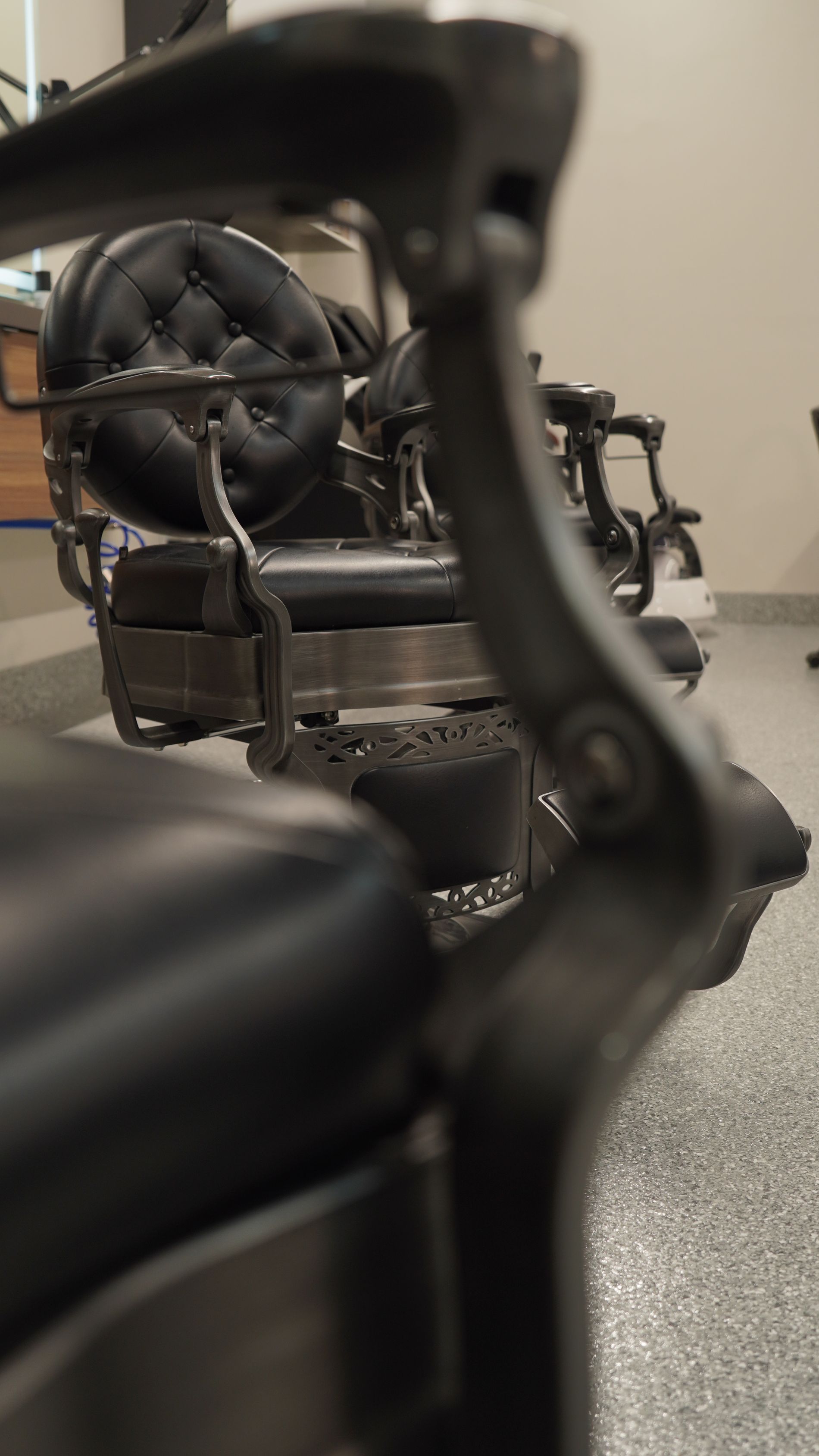Antique black leather barber chair in a barbershop.