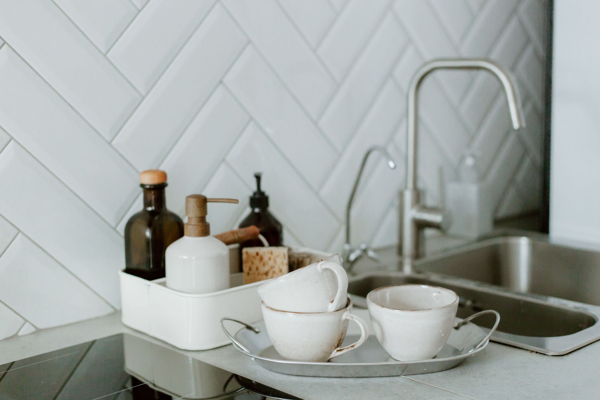Clean kitchen counter with a soap dispenser next to the sink