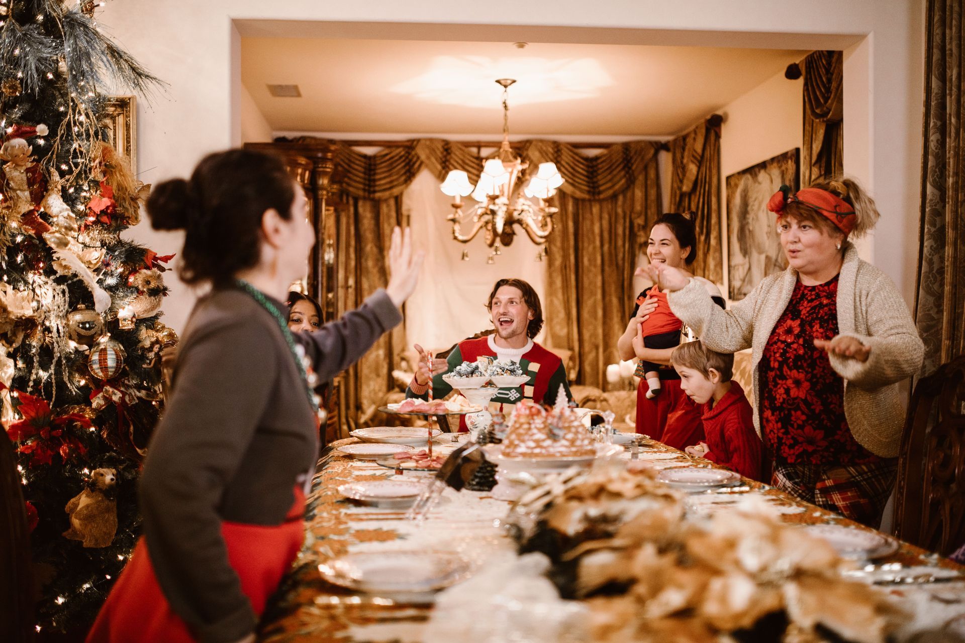 Family singing together around a Christmas dinner table